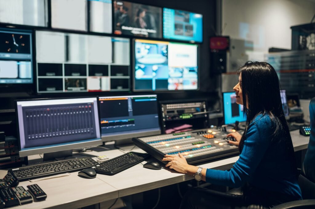 Middle aged woman using equipment in control room on a tv station